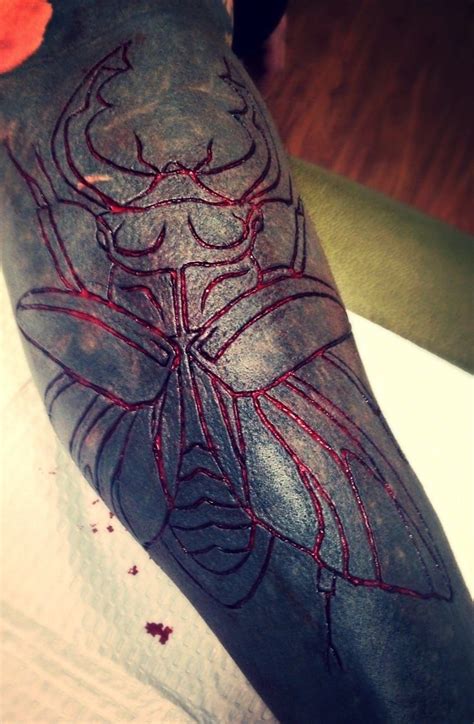 scarification on black tattoo